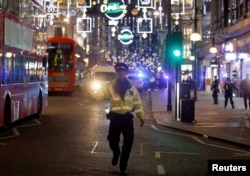 A police officer walks along Oxford Street, in central London, Britain, Nov. 24, 2017.