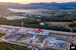 In this photo released by Xinhua News Agency, an aerial view shows Ganlanba railway station, one of the stations along the China-Laos railway, under construction Sept. 28, 2021, in China's southwestern Yunnan province.