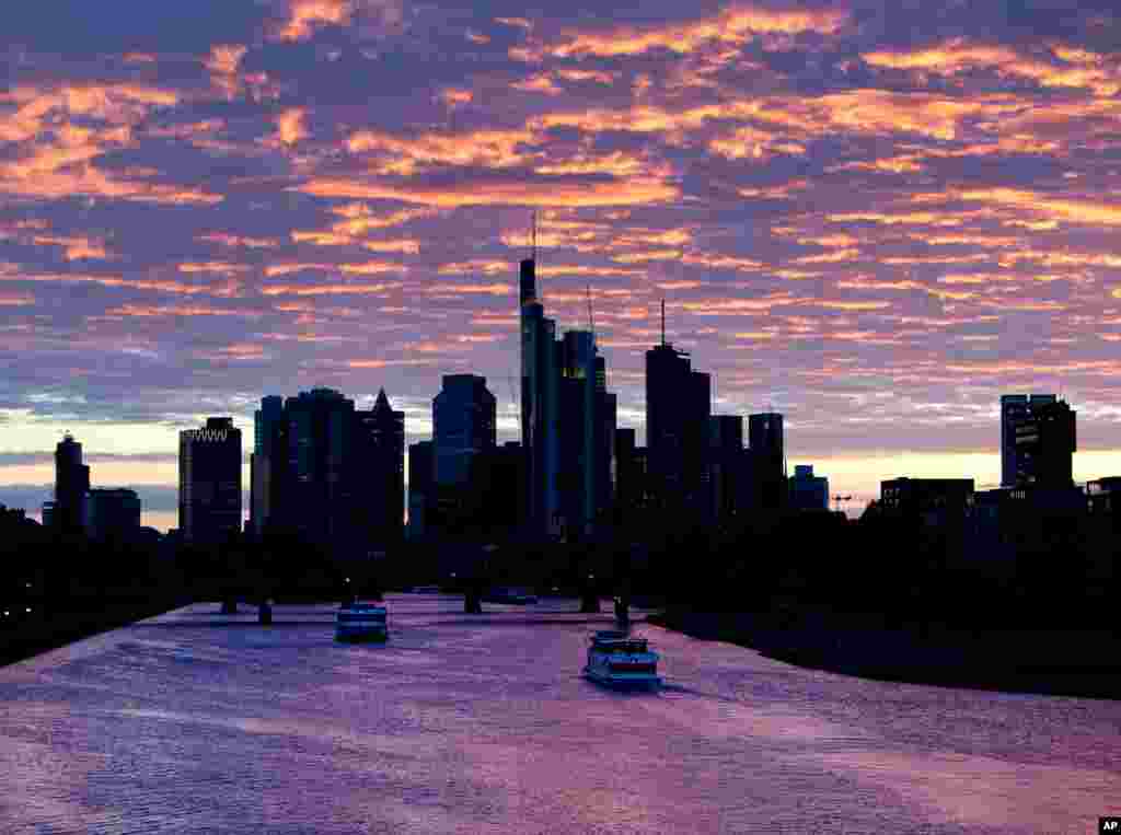 Ships pass by on the river Main after the sun set in Frankfurt, Germany, May 15, 2019.