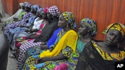 Some of the escaped kidnapped girls of the government secondary school Chibok, attend a meeting with Borno state governor, Kashim Shettima, in Maiduguri, Nigeria, June 2, 2014. 