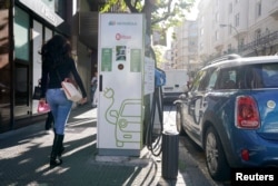 An electric car is charged from an Iberdrola electric car charging station in central Bilbao, Spain, Nov. 15, 2018.