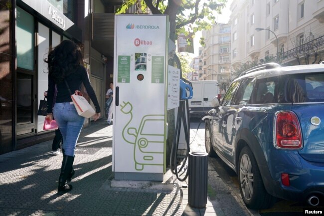 An electric car is charged from an Iberdrola electric car charging station in central Bilbao, Spain, Nov. 15, 2018.