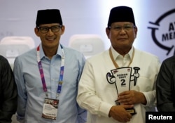 Presidential candidate in next year's election Prabowo Subianto, right, a retired special forces commander, and his running mate Sandiaga Uno attend a ceremony at the election commission headquarters in Jakarta, Indonesia, Sept. 21, 2018.