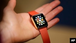 A woman holds the Apple Watch Edition during a demo following an Apple event Monday, March 9, 2015.