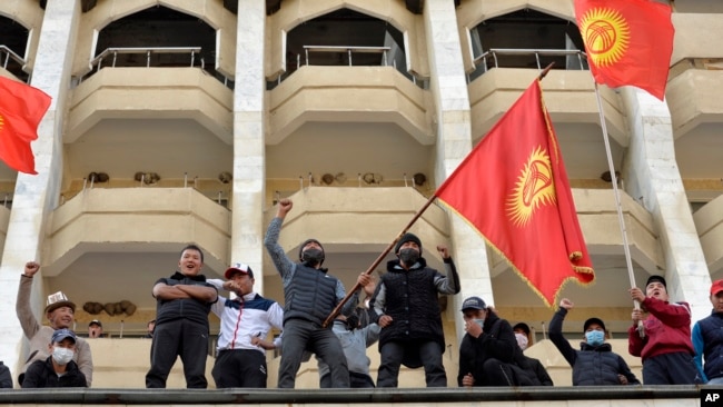 Supporters of Kyrgyzstan's Prime Minister Sadyr Japarov attend a rally in Bishkek, Kyrgyzstan, Oct. 15, 2020. Kyrgyzstan President Sooronbai Jeenbekov announced his resignation in a bid to end the turmoil that has engulfed the Central Asian nation. (AP Photo/Vladimir Voronin)