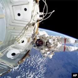Jeffrey Williams performs a spacewalk outside the station during the STS-101 shuttle mission in May of 2000.