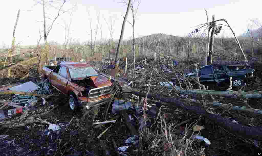 Vehicles and debris are scattered in an area near Linden, Tennessee, USA. Several people were killed in Mississippi, Tennessee and Arkansas as spring-like storms mixed with unseasonably warm weather spawned rare Christmas time tornadoes in the South.