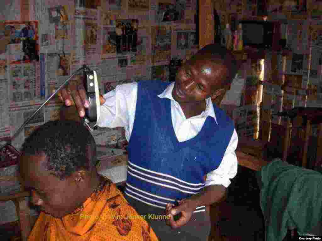 Electricity has allowed villagers, like this man who’s established a barbershop, to open businesses. (Practical Action)