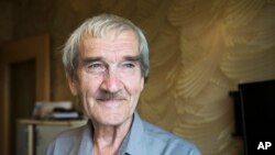 FILE - Former Soviet missile defense forces officer Stanislav Petrov poses for a photo at his home in Fryazino, Moscow region, Russia, Aug. 27, 2015. Petrov, a former Soviet military officer known in the West as "The man who saved the world'' for his role in averting a nuclear war over a false missile alarm, died in May at age 77. 