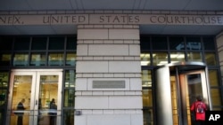 People enter the Federal Court, Oct. 30, 2017, in Washington. 