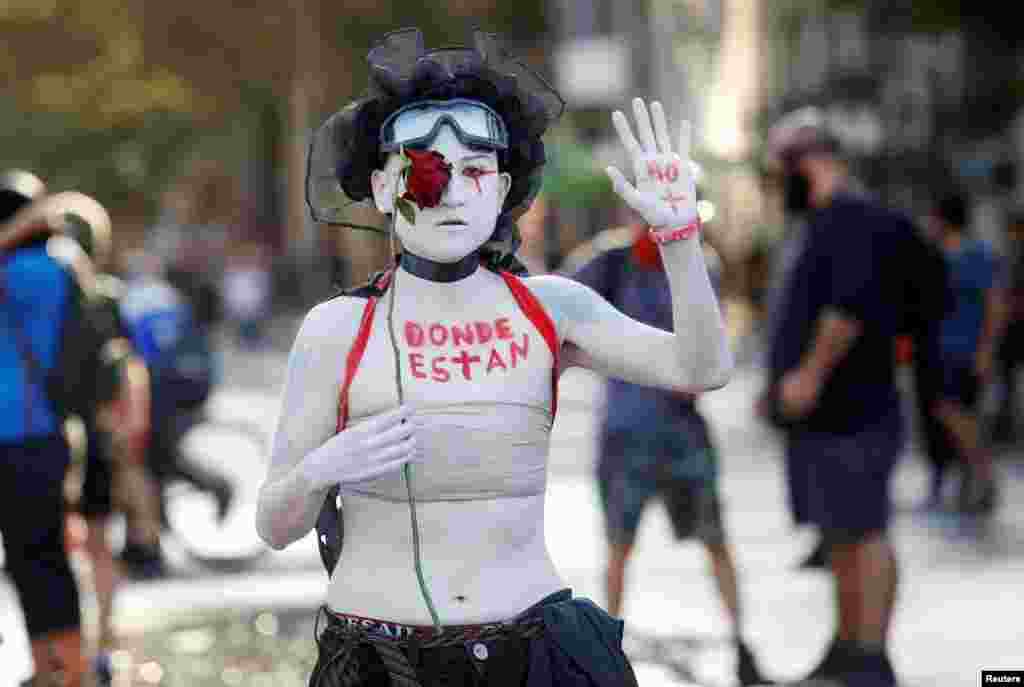 A demonstrator with words painted on her body reading &quot;where are they?&quot; takes part in a protest against Chile&#39;s government in Santiago, Chile, Feb. 18, 2020.