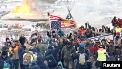 Opponents of the Dakota Access oil pipeline march out of their main camp near Cannon Ball, North Dakota, U.S., February 22, 2017.