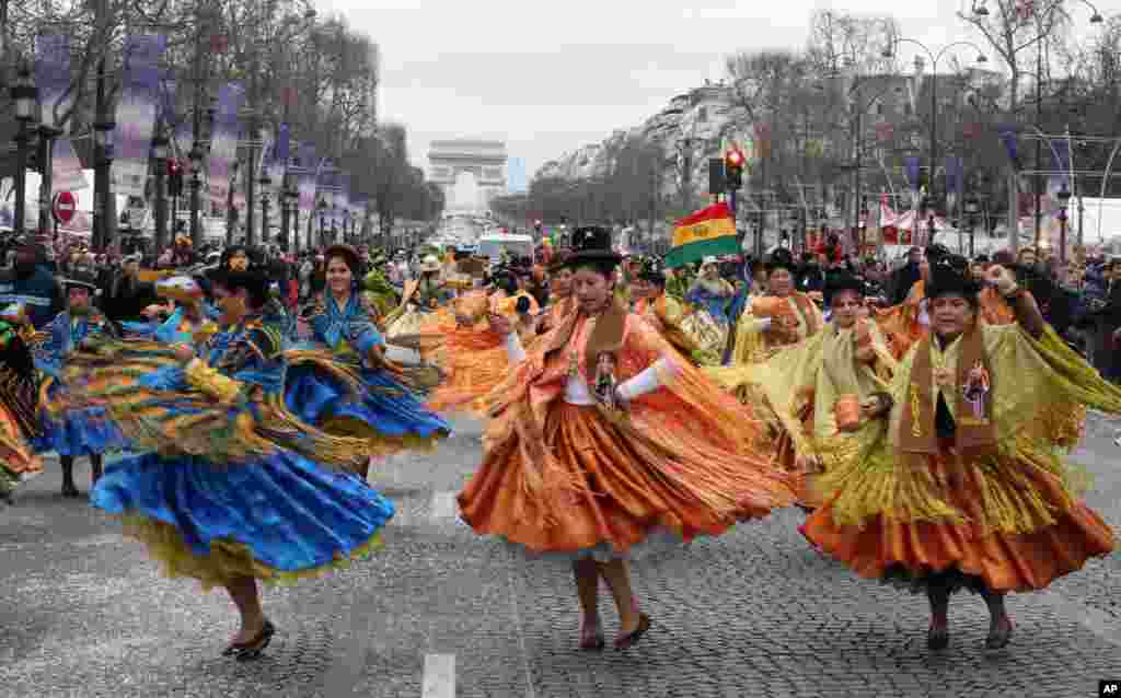 Bolivian dancers perform on the Champs Elysees to celebrate the new year, Paris, France, Jan. 1, 2014,