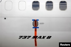 FILE PHOTO: A seal is seen on Garuda Indonesia's Boeing 737 Max 8 airplane parked at the Garuda Maintenance Facility AeroAsia, at Soekarno-Hatta International airport near Jakarta, Indonesia, March 13, 2019. REUTERS/Willy Kurniawan/