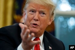 President Donald Trump speaks during an interview with The Associated Press in the Oval Office of the White House, Oct. 16, 2018, in Washington.