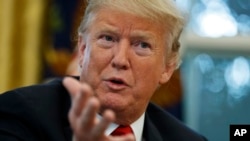 FILE - President Donald Trump speaks during an interview with The Associated Press in the Oval Office of the White House, Oct. 16, 2018, in Washington. 