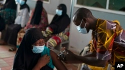 FILE - A health worker administers a dose of the Johnson & Johnson COVID-19 vaccine at the Bundung Maternal and Child Health Hospital, in Serrekunda, outskirts of Banjul, Gambia, Sept. 23, 2021. 