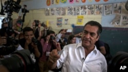 Jaime Rodriguez, known as "El Bronco," an independent candidate for governor of the northern state of Nuevo Leon, shows his inked finger after casting his vote in Villa de Garcia, Mexico, Sunday, June 7, 2015.