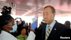 U.N. Secretary General Ban Ki-moon has his temperature checked upon arrival at the Roberts International airport in Liberia's capital Monrovia, Dec. 19, 2014.
