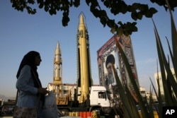 A Ghadr-H missle, center, a solid-fuel surface-to-surface Sejjil missile and a portrait of the Supreme Leader Ayatollah Ali Khamenei are on display for the annual Defense Week, at Baharestan Square in Tehran, Iran, Sept. 24, 2017. Iran's elite Revolutionary Guard displayed the country's sophisticated Russian-made S-300 air defense system in public for the first time.