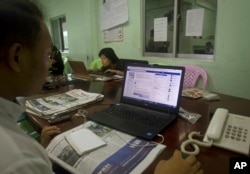 A reporter of The Voice Daily looks at its website as he and other reporters work in their newsroom in Yangon, Myanmar, June 5, 2017.