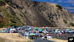 People who are against the construction of a Hawaii telescope continuing to block the roadway to the top of Mauna Kea, a mountain considered sacred by some Native Hawaiians, July 18, 2019.