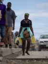 A person carries containers filled with gasoline to sell on the streets in Cap-Haitien, Haiti April 29, 2024.