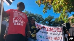 FILE - Edward Moore and Sandra Reed, mother of death row inmate Rodney Reed, rally outside the Texas governor’s mansion in Austin, Texas, Nov. 9, 2019.