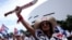 A woman shouts as she attends a rally ahead of an opposition demonstration in Cuba, in Miami, Florida, Nov. 14, 2021. 