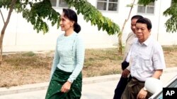 Myanmar's new de facto leader Aung San Suu Kyi, left, arrives at a hospital for her eye operation in Naypyitaw, April 9, 2016. 