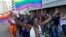 A woman holds her hands up during the Durban Pride parade where several hundred people marched through the city center in support of gay rights, July 30, 2011 file photo. 