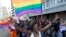 FILE - A woman holds her hands up during the Durban Pride parade where several hundred people marched through the city center in support of gay rights, July 30, 2011 file photo. 