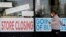 FILE - A man looks at signs of a closed store due to COVID-19 in Niles, Ill., May 21, 2020.