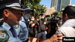 FILE - Police clash with protesters on Australia Day demanding that the country's national day be changed, as the date marks the arrival of Britain's first fleet and subsequent colonization of indigenous Australians, at a march in Sydney, Jan. 26, 2021.