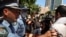 FILE - Police clash with protesters on Australia Day demanding that the country's national day be changed, as the date marks the arrival of Britain's first fleet and subsequent colonization of indigenous Australians, at a march in Sydney, Jan. 26, 2021.