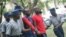 Occupy Africa Leaders Itai Dzamara (left) and Tichaona Danho (right) being detained by Zimbabwe Republic Police. File photo.