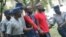 FILE: Occupy Africa Unity Square leaders Itai Dzamara (left) and Tichaona Danho (right) detained by police.