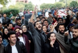 Protesters shout slogans during a protest against the Citizenship Amendment Bill, inside the Jamia Millia Islamia University in New Delhi, Dec. 14, 2019.