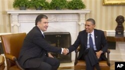 President Barack Obama shakes hands with Georgian President Mikhail Saakashvili during their meeting in the Oval Office of the White House in Washington, Monday, Jan., 30, 2012.