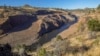 This image provided by Swiftwater Films shows water flowing down the Klamath River where the Iron Gate Dam once stood near Hornbrook, California, Oct. 1, 2024. (Swiftwater Films via AP)