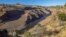 This image provided by Swiftwater Films shows water flowing down the Klamath River where the Iron Gate Dam once stood near Hornbrook, California, Oct. 1, 2024. (Swiftwater Films via AP)