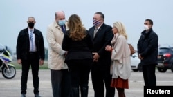 U.S. Secretary of State Mike Pompeo and his wife Susan Pompeo speak with Jacques Jouslin de Noray of the French Foriegn Ministry and U.S. Ambassador to France Jamie McCourt, after arriving at Paris-Le Bourget Airport, in Le Bourget, France, Nov. 14, 2020.