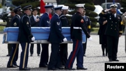 Members of the United Nations Command honor guards carry boxes containing the remains of a United Nations Command soldier who was killed inside North Korea in the 1950-53 Korean War, during a jointly held repatriation ceremony at Knight Field in Seoul, South Korea, April 28, 2016. 