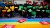 Demonstrators pose with the pieces of paper in the colors of the Olympic rings during a protest against Russia's anti-gay laws ahead of the Sochi 2014 Olympic Games, in Madrid, Feb. 5, 2014.