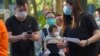 People queue up to vote in Hong Kong, Sunday, July 12, 2020, in an unofficial primary for pro-democracy candidates ahead of legislative elections in September.