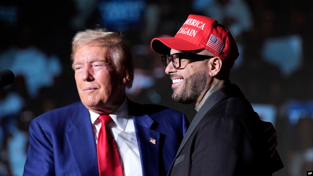 ARCHIVO - El expresidente Donald Trump, candidato presidencial republicano, a la izquierda, saluda a Nicky Jam durante un evento de campaña en el World Market Center, el 13 de septiembre de 2024, en Las Vegas.
