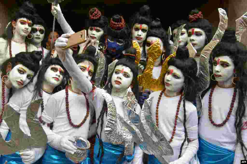 Indian schoolchildren dressed as Hindu God Lord Shiva pose for a &#39;selfie&#39; ahead of their performance during an annual school function in Amritsar.