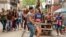 This image released by Warner Bros. Picures shows Anthony Ramos, foreground left, and Melissa Barrera in a scene from "In the Heights."