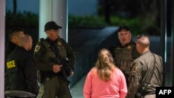 FILE - Armed law enforcement officials guard the ambulance entrance to the Central Maine Medical Center in Lewiston, Maine early on October 26, 2023.