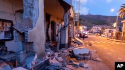 Debris from a partially collapsed house sits on a street in Fleri, Sicily Italy, Dec. 26, 2018.